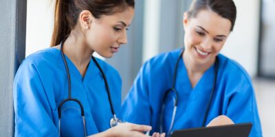 15692949 - two beautiful female healthcare workers using laptop